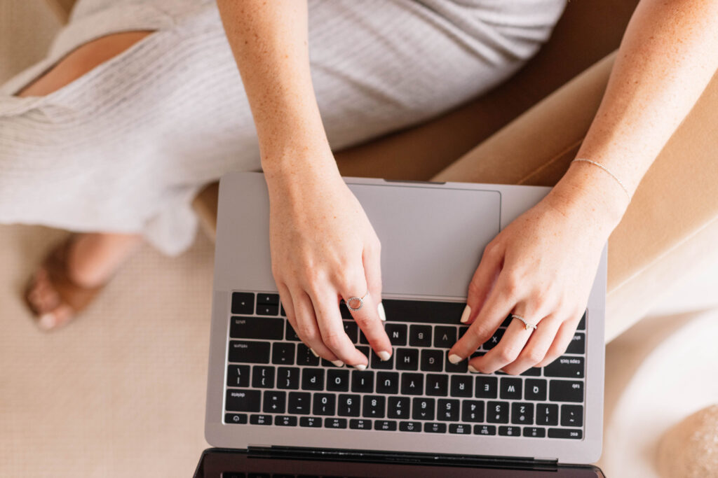 Hands displayed over a keyboard from a woman who is sitting on a brown chair. Book your first session Online today with a trauma trained therapist! We offer virtual services across Ontario. We provide EMDR and Somatic Experiencing.